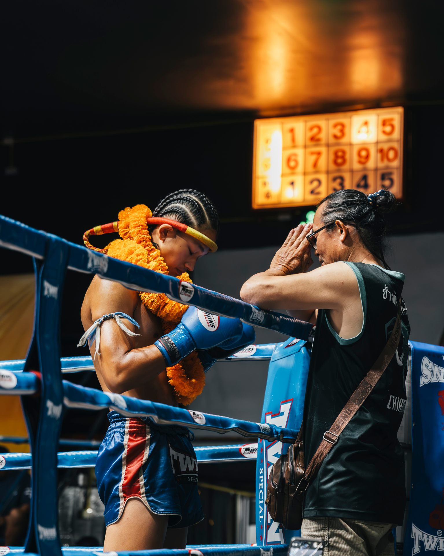 A Muay Thai fighter receiving a blessing before a fight